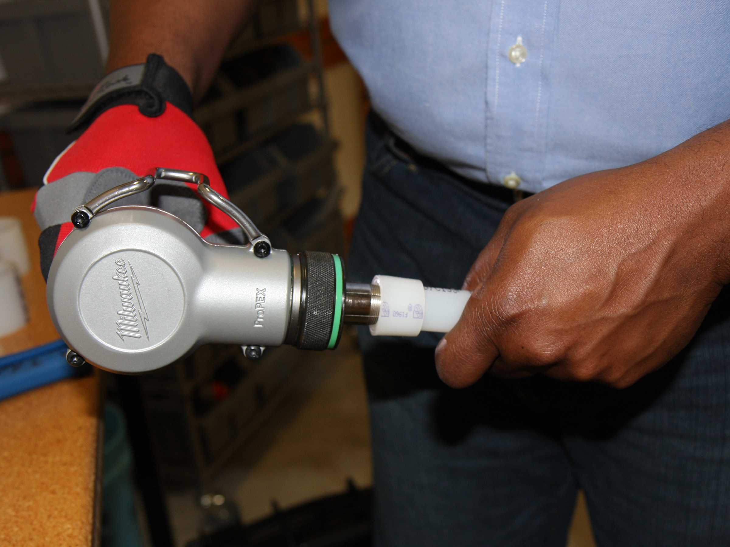 Person using a Milwaukee power tool.